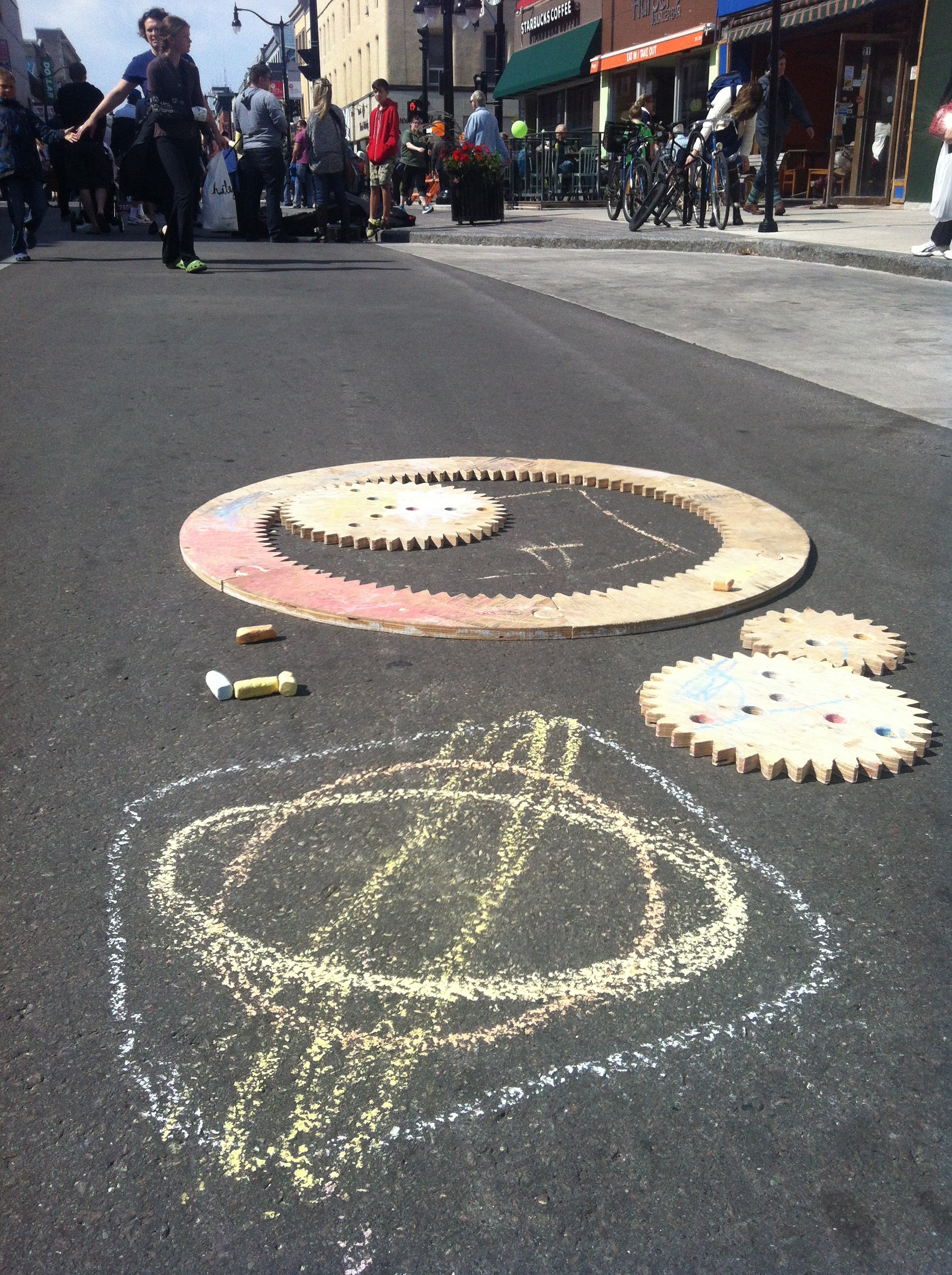 photo of sidewalk sized spirograph in action