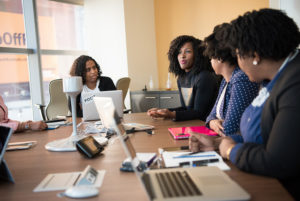 business women meeting with laptops at a boardroom table