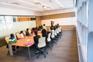 meeting room showing mostly women and mostly people of color