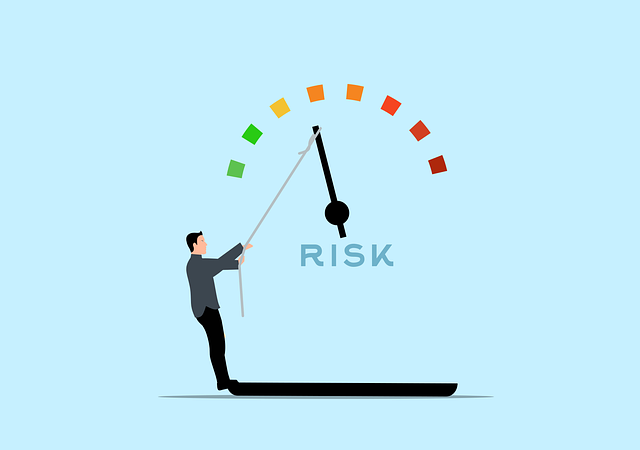 person lowering the dial on an oversized risk meter by pulling a rope on the indicator